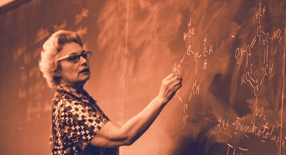 Teacher writing on a blackboard