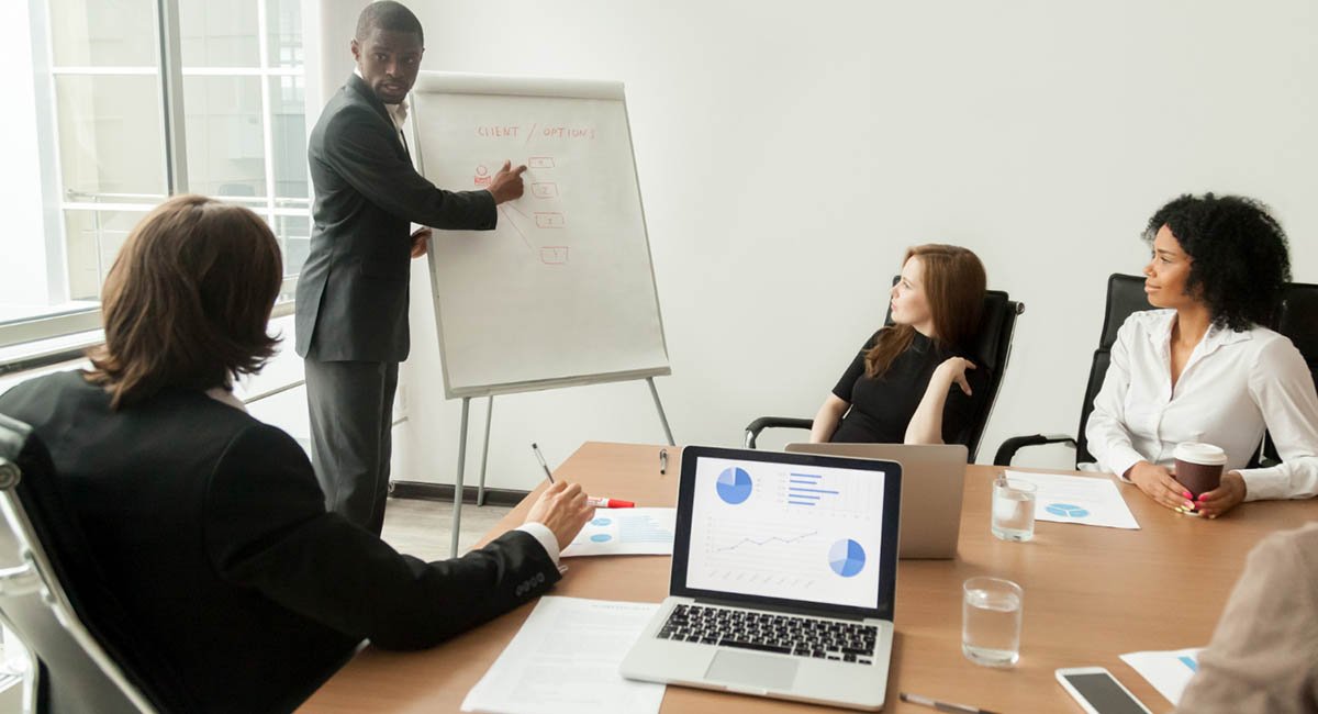 Business man giving presentation to diverse colleagues