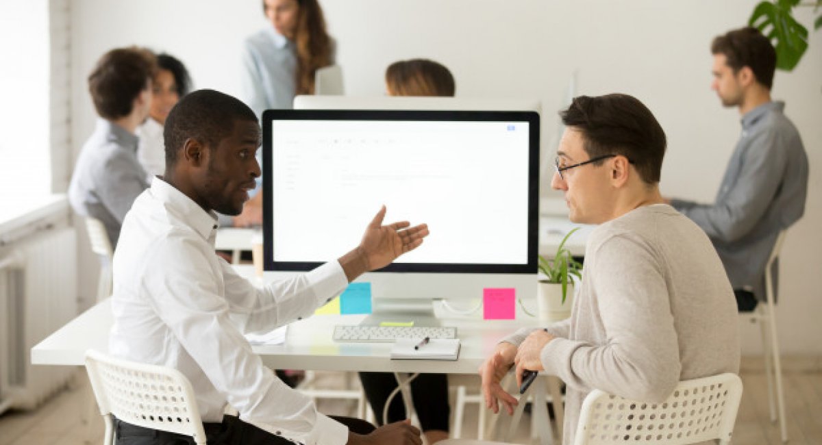 businesspeople around computer