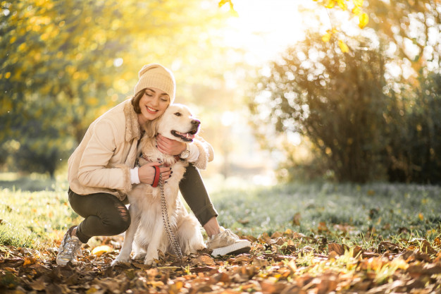 A young woman hugging her dog