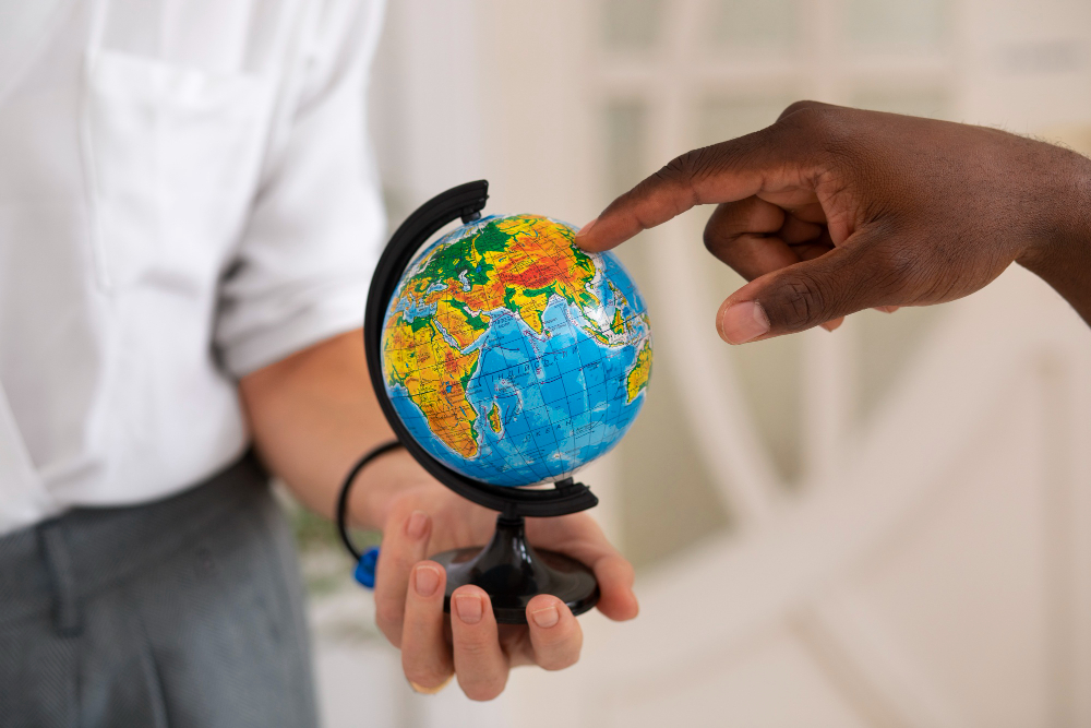 Two men looking at the world globe