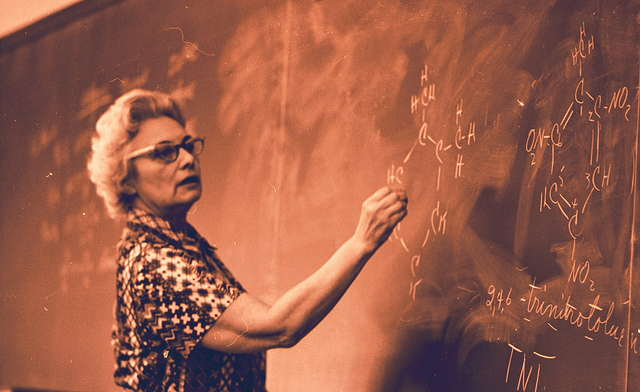 Teacher writing on a blackboard