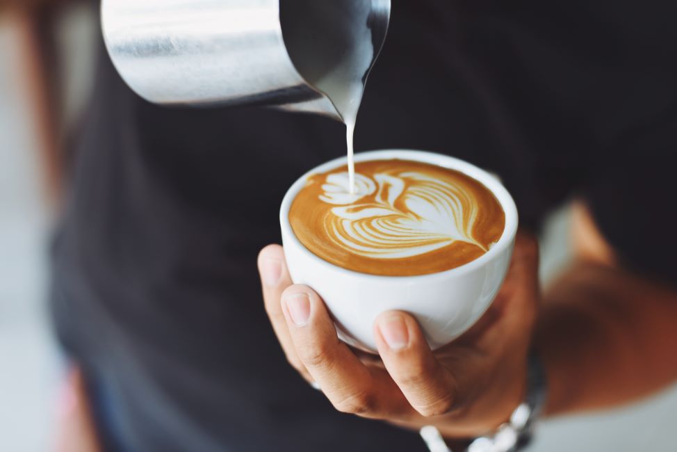 Person Holding White Cup