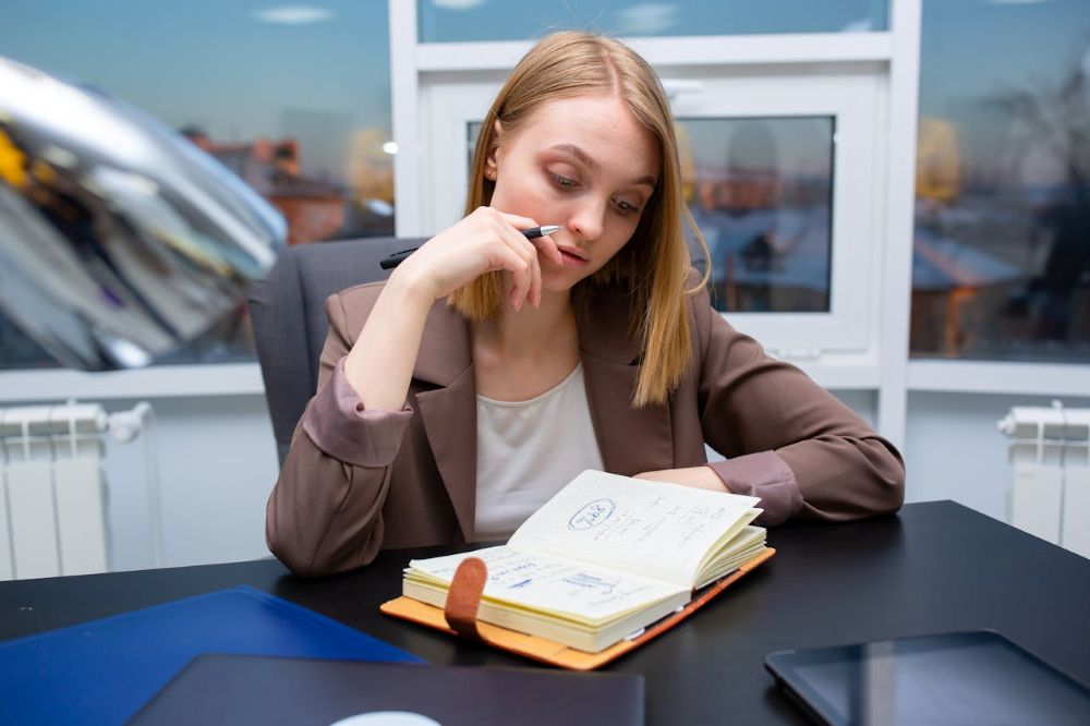 A woman in a brown blazer sitting at a table