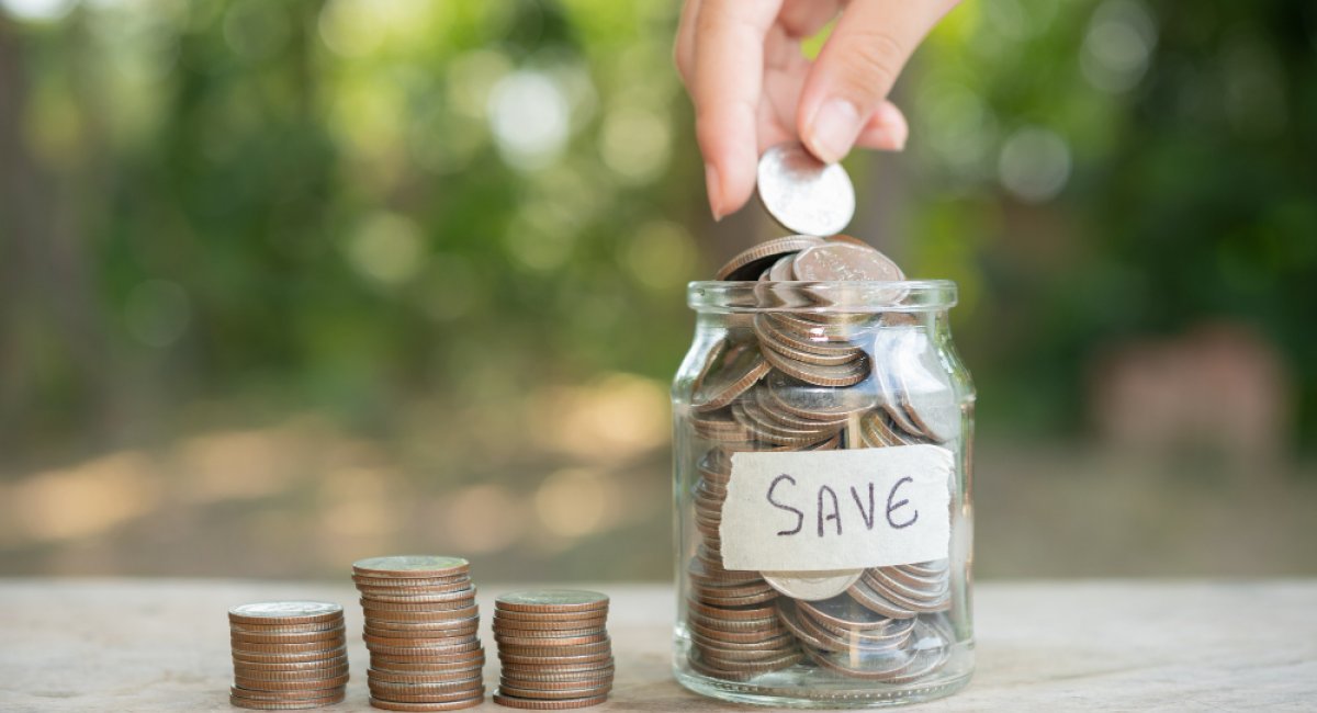 Placing coins in a glass jar
