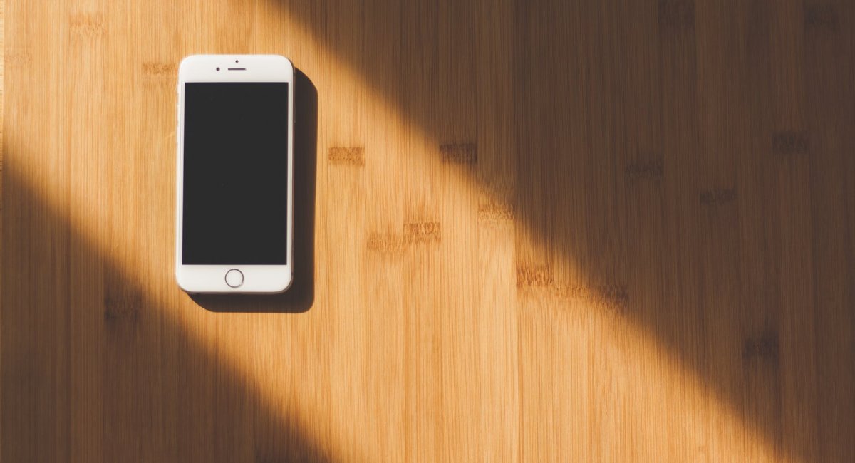 White Apple Iphone on Wooden Table