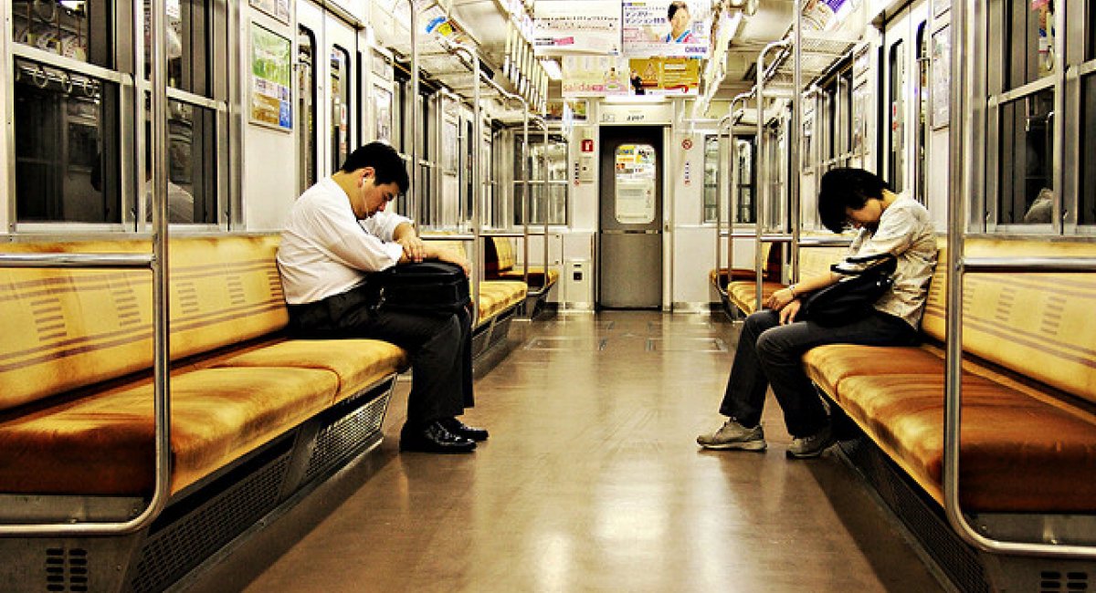 Two men asleep on the train