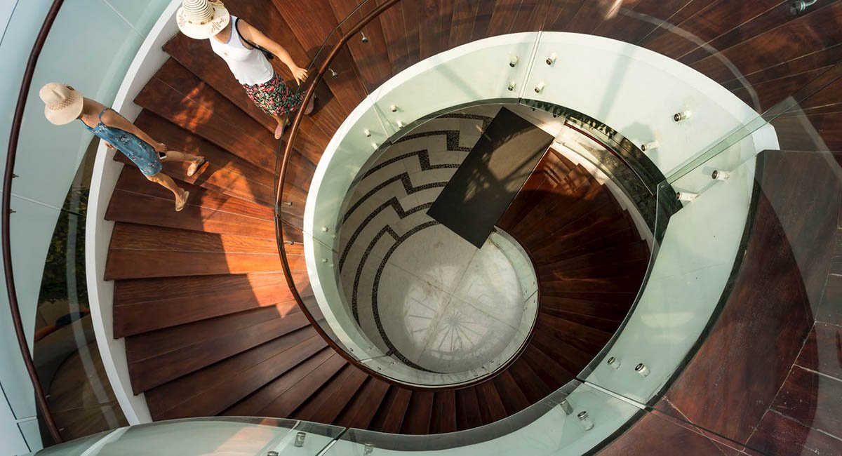 Two women going down a spiral staircase