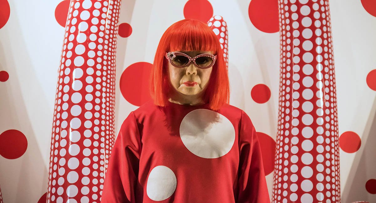 People use their smartphones to take pictures of the Yayoi Kusama